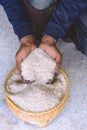 Close up raw jasmine white rice grain in agriculture hand vertical. Royalty Free Stock Photo