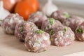 Close up, Raw meatballs on a cutting board.