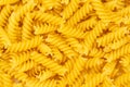 Close-up of raw pasta, texture or background Fusilli. Raw and Dry Macaroni. Italian Culture Royalty Free Stock Photo