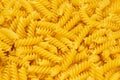 Close-up of raw pasta, texture or background Fusilli. Raw and Dry Macaroni. Italian Culture Royalty Free Stock Photo