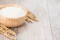 Close up raw rice and unmilled rice in traditions bamboo basket on wooden background, copy spacetext space, blank for text Royalty Free Stock Photo