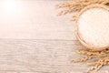 Close up raw rice and unmilled rice in traditions bamboo basket on wooden background, copy spacetext space, blank for text Royalty Free Stock Photo