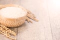 Close up raw rice and unmilled rice in traditions bamboo basket on wooden background, copy spacetext space, blank for text Royalty Free Stock Photo