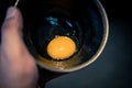 Close-up raw uncooked egg in black bowl Royalty Free Stock Photo