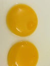 Twin raw egg yolks in bowl