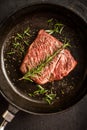 Close up raw wagyu beef striploin steak with pepper on dark pan. Restaurant Royalty Free Stock Photo