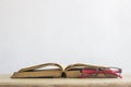 Close-up of a reading glasses on an open book on a white background Royalty Free Stock Photo