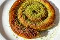 Close up turkish dessert kadayif. shredded wheat dessert with pistachio filling