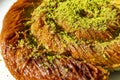 Close up turkish dessert kadayif. shredded wheat dessert with pistachio filling