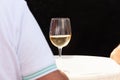 Close-up of real people holding a glass of Prosecco