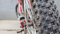 Close-up rear bicycle wheel of a parked mountain red bicycle. rear view old bicycle wheel texture vintage style Royalty Free Stock Photo