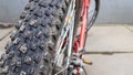 Close-up rear bicycle wheel of a parked mountain red bicycle. rear view old bicycle wheel texture vintage style Royalty Free Stock Photo