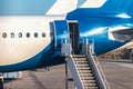 Close-up of rear door open and a passenger airstairs of a jet airplane at the airport Royalty Free Stock Photo