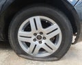 rear flat tire from a black car Royalty Free Stock Photo