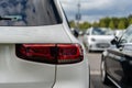 Close-up of the rear lamp of a car parked with a blurry image of the other cars in a public place Royalty Free Stock Photo