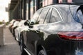 Close-up of the rear lamp of a car parked with a blurry image of the other cars in a public place Royalty Free Stock Photo