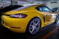 Close-up of Rear light or Tail lamp, Wheel and Door of Yellow porsche sports car parked in the parking lot Royalty Free Stock Photo