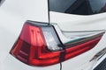 Close up of rear lights detail of modern luxury car with projector lens for low and high beam. Front view of sport Royalty Free Stock Photo