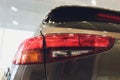 Close up of rear lights detail of modern luxury car with projector lens for low and high beam. Front view of sport Royalty Free Stock Photo