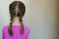 Close up rear- vew portrait of a cute little girl with funny pigtails on white background. Fashion and happy childhood. Royalty Free Stock Photo