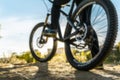 Foot on bike pedal at sunset. Close up rear view cyclist pedalling. Bicycle on the road. Royalty Free Stock Photo