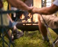 Close Up Rear View Of Loving Senior Couple Camping In Countryside With RV Holding Hands By Fire Royalty Free Stock Photo