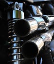 Close up rear view of a powerful classic black vintage motorcycle showing suspension and shiny chrome exhaust pipes Royalty Free Stock Photo