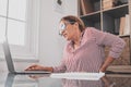 Close up rear view stressed young woman touching lower back feeling discomfort, suffering from sudden pain due to sedentary Royalty Free Stock Photo