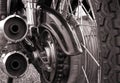 Close up rear view of a vintage motorcycle with tyre treads wheel spokes drive chain and shiny chrome springs Royalty Free Stock Photo