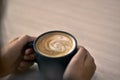 Close-up rear view, Warm coffee in a woman hand.