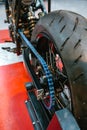 Close up of rear wheel and decorative blue chain on custom motorbike on factory Royalty Free Stock Photo