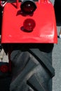 Close up of the rear wheel and fender of a classic red tractor Royalty Free Stock Photo