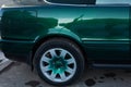 Close up rear wheel right of a green sports car, rear wheel drive Royalty Free Stock Photo