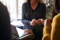 Close Up Of Receptionist Handing Guest Couple Key As They Check Into Hotel