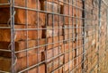 Close up of reclaimed bricks stacked in a metal cage