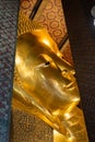 A close up of Reclining Buddha gold statue face. Wat Pho Royalty Free Stock Photo