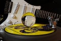 Close up of record player with yellow punk vinyl LP and crystal sphere glass ball und blurred electric guitar with black Royalty Free Stock Photo