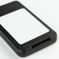 A close-up of a rectangular black electronic device with a white label on the front. The Royalty Free Stock Photo