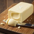 A close up of a rectangular block of butter placed on a wooden cutting Royalty Free Stock Photo