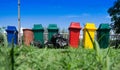 Recycle waste bins and black plastic bag on grass