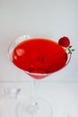 Close-up of red alcohol cocktail with raspberry and thyme on white wood table. Royalty Free Stock Photo