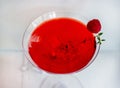 Close-up of red alcohol cocktail with raspberry and thyme on white wood table. Royalty Free Stock Photo