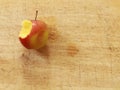 Close up red apple with a bite on a wooden board from above Royalty Free Stock Photo