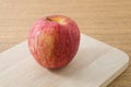 Close Up Red Apple on A Wooden Cutting Board Royalty Free Stock Photo