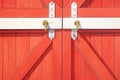 close-up of red barn doors with metal hinges Royalty Free Stock Photo