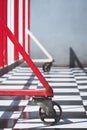 Red barrier on chessboard pattern of tile floor in auto accessories workshop area