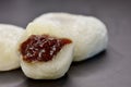 Close-up of red bean filling in mochi, or Japanese rice cake, on black table top Royalty Free Stock Photo