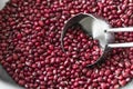 Close up red beans in measuring cup, Measuring cup scooping organic red beans in aluminum bowl Royalty Free Stock Photo