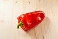 Close-up red bell pepper on a wooden background. Fresh red pepper is organic vegetable, top view. Vitamin red product