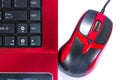 Close up of red and black computer mouse and laptop isolated on white background Royalty Free Stock Photo